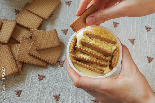 Trendy viral Japanese yogurt cheesecake with cookies biscuit. Preparation of tasty no bake dessert treat at home