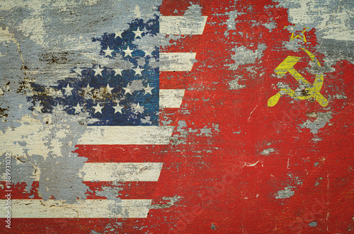 flag of the United States of America and the flag of the Soviet Union are painted on an old stone wall