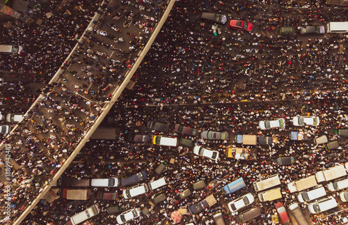 Dhaka, Bangladesh - 31 December 2025: Aerial view of a sea of people and vehicles creating a tapestry of motion beneath the city's concrete veins.