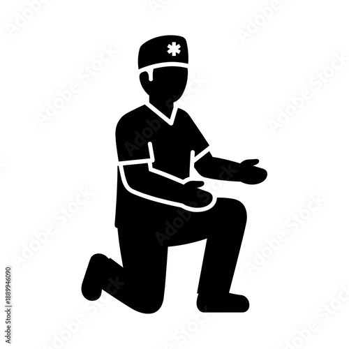 A dedicated healthcare professional in medical scrubs and a cap kneels down, extending an open hand in a gesture of care or assistance, symbolizing medical support and patient interaction.