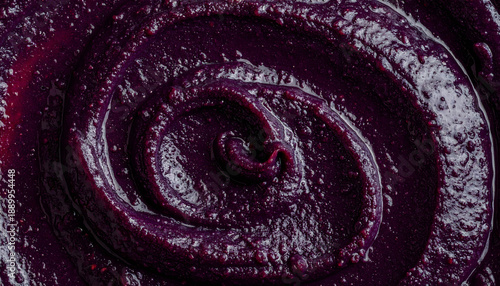 Dark purple blueberry jam or puree swirl texture macro top view