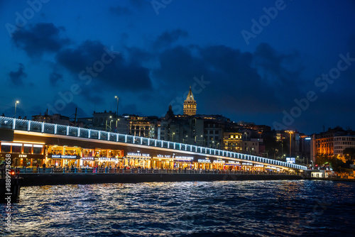 Illuminated Galata bridge after sunset. Istanbul, Turkey.