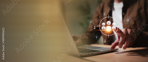 Canvas Print Businessman using a laptop to define a target audience or human resources, with floating icons representing security, idea, goal, and growth