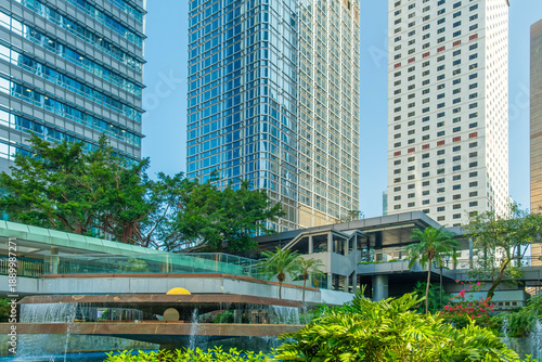 Photography Modern urban park Chater garden with fountain surrounded by skyscrapers and greenery in Hong Kong city, China
