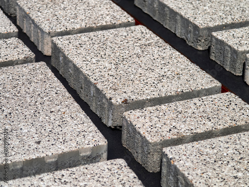 Light gray concrete blocks arranged on a surface for construction work at a building site during daylight hours