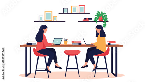 Two women sitting at a long wooden table working on their laptops in a bright and modern coworking office space with plant decor.