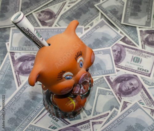 piggy bank with dollar bills