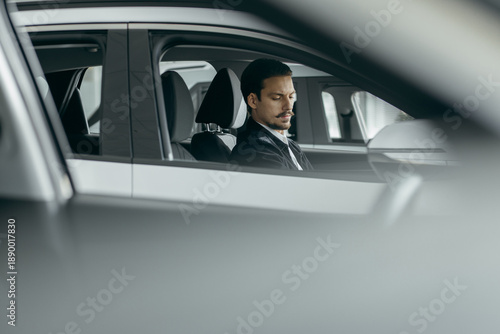 Man choosing new car in dealership