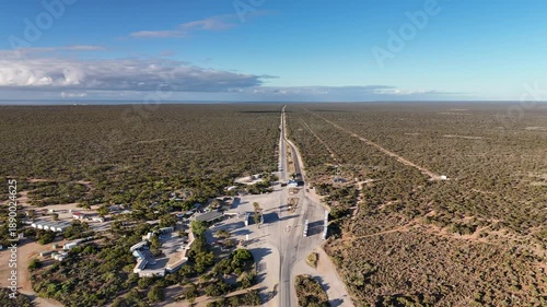 Border Village between South Australia and Western Australia, Eyre Highway, Nullarbor Plain: 4K aerial drone footage of remote roadhouse, boder control, Vehicles, outback highway and vast wilderness