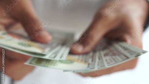 Blur. Man counting out dollar bills for an investment. Currency. Financial job concept. Concept of a deal.