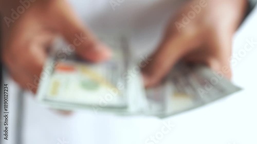 Blur. Man counting out dollar bills for an investment. Currency. Financial job concept. Concept of a deal.