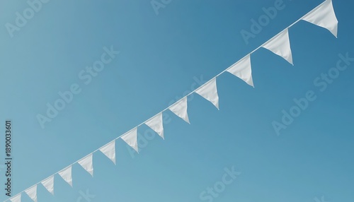 A string of triangular white flags hangs diagonally against a clear blue sky with a subtle gradient effect.
