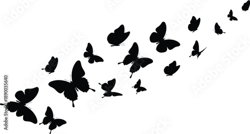 A flock of butterflies flying together in a diagonal line from bottom left to top right viewpoint