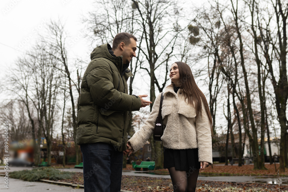 Fototapeta premium Young couple walking in the park