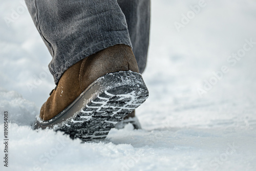 Obraz na plátně Close up of winter boots stepping on fresh snow outdoors