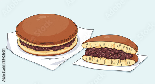 Two delicious dorayaki Japanese pancakes filled with sweet red bean paste shown as a whole and sliced in half.