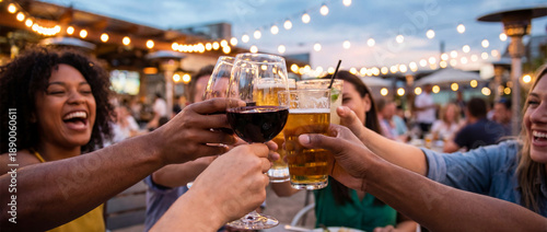 Wallpaper Mural Friends toasting with drinks at outdoor celebration, joyful atmosphere with laughter and glowing lights. Friends enjoy bonding time with glasses of wine, beer, and cocktails in lively setting. Torontodigital.ca