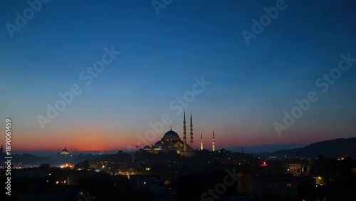 A serene video of a mosque at sunset with a vibrant blue and orange sky