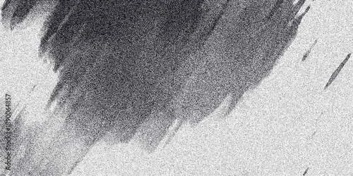 Abstract monochrome background with a large dark speckled area transitioning to a lighter speckled texture with diagonal streaks Keywords: abstract, monochrome, background, texture, speckled