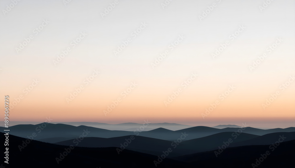 Obraz premium Peaceful mountain silhouettes in soft atmospheric light