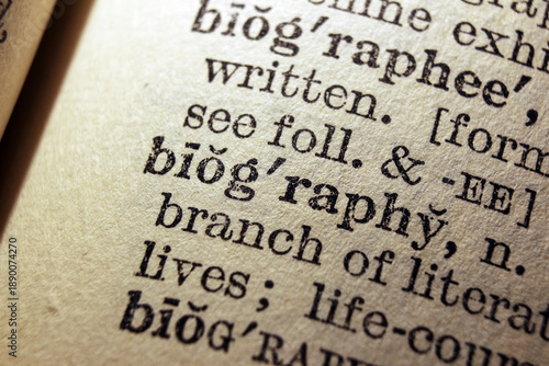 Word biography printed on dictionary page, macro close up