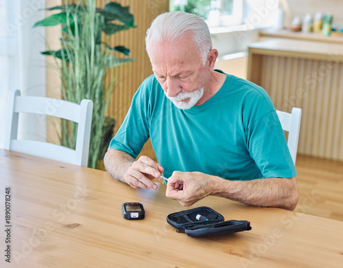 Wallpaper Mural Portrait of senior man using lancet on finger for checking blood sugar level with glucose meter. Healthcare and medical, diabetes, glycemia concept Torontodigital.ca