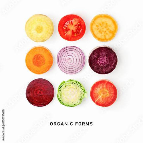 Organic vegetable slices pattern isolated on white background. Colorful flat lay composition featuring beetroot, carrot, tomato, cabbage, sweet potato and onion