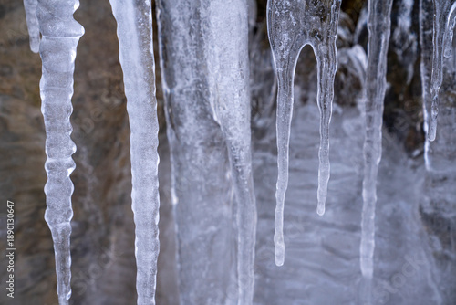 The Gleiersch Gorge in winter with snow, ice, and hanging icicles.