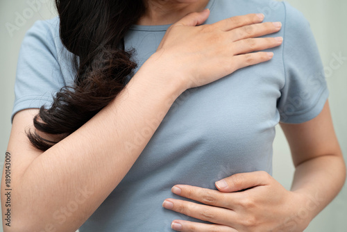 Asian woman self touching check lump or Breast cancer, Breast Self Exam.