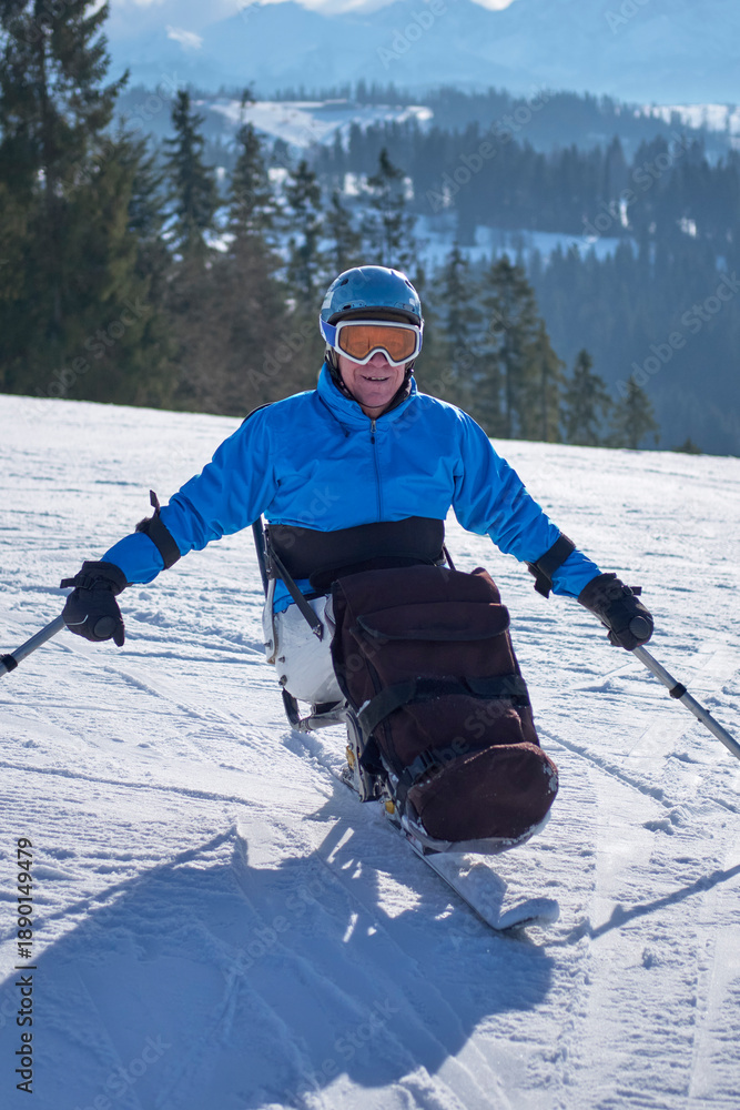 © Alex - a skier in a blue jacket poses
