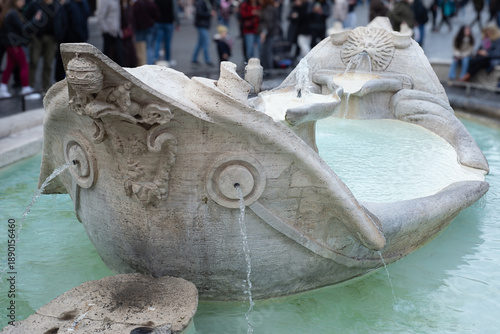 Wallpaper Mural Water flows from the Barcaccia fountain at the Spanish Steps as visitors pause in soft winter light in Rome, Italy Torontodigital.ca