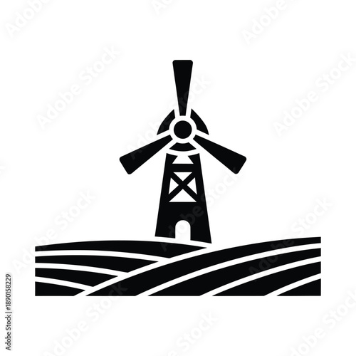 Windmill silhouette on a field representing green energy