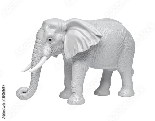 A white, realistic toy elephant sculpture with tusks on a black background