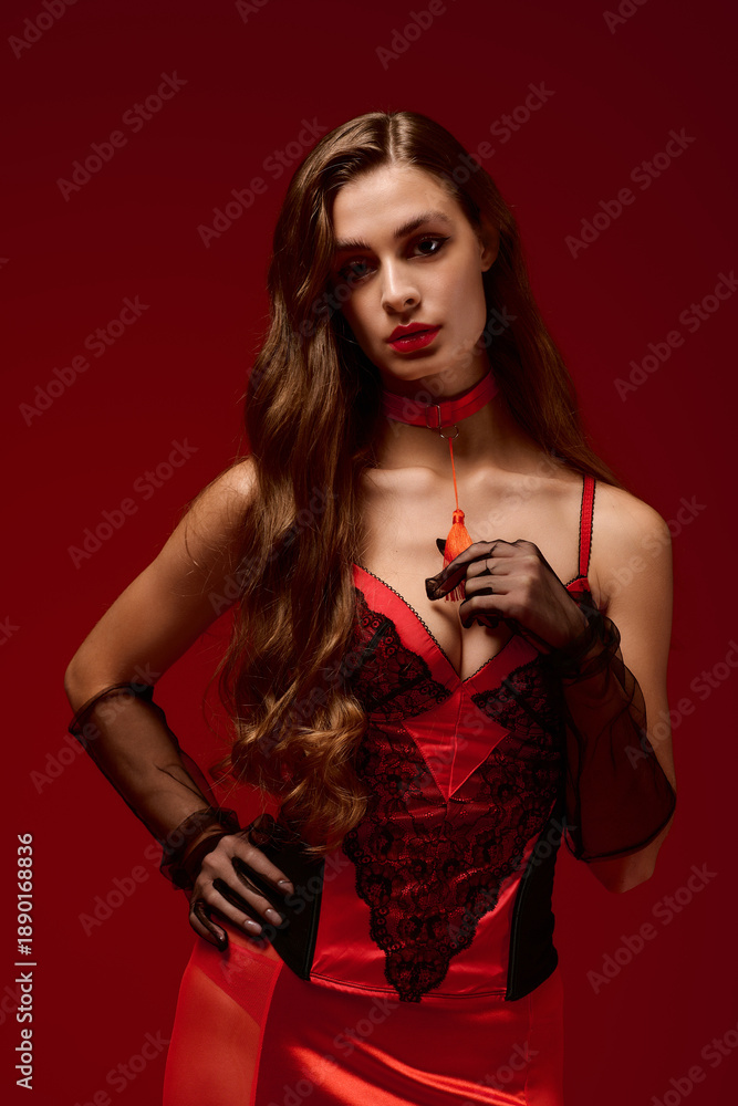 Naklejka premium Elegant lingerie model on a vibrant red backdrop for Valentine's Day