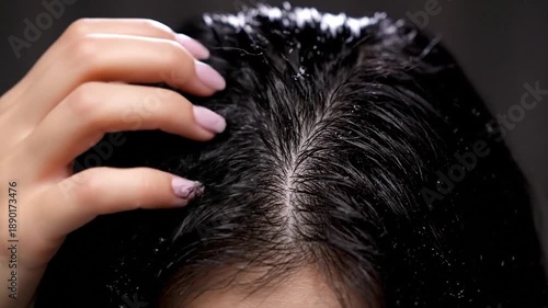 Close-up view of hands parting black hair
