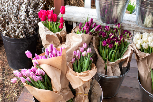 Wallpaper Mural Tulip flowers, fresh flowers for sale. Bunches of different colorful flowers in buckets in flower market on a city street. Vibrant display of assorted tulips at a floral shop outdoors.   Torontodigital.ca