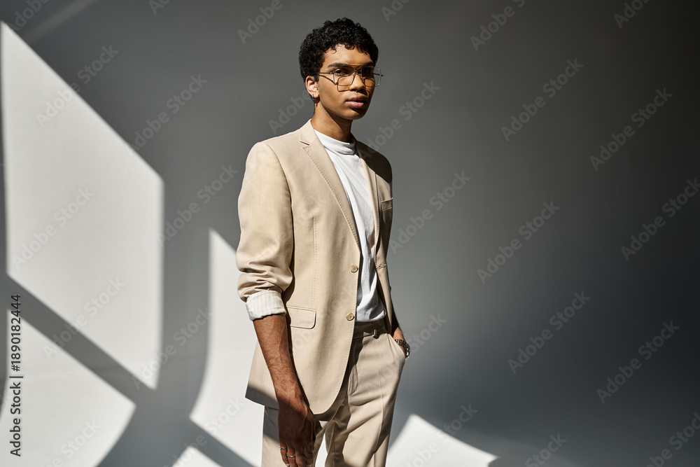 Obraz premium Stylish young African American man in glasses posing elegantly in a studio