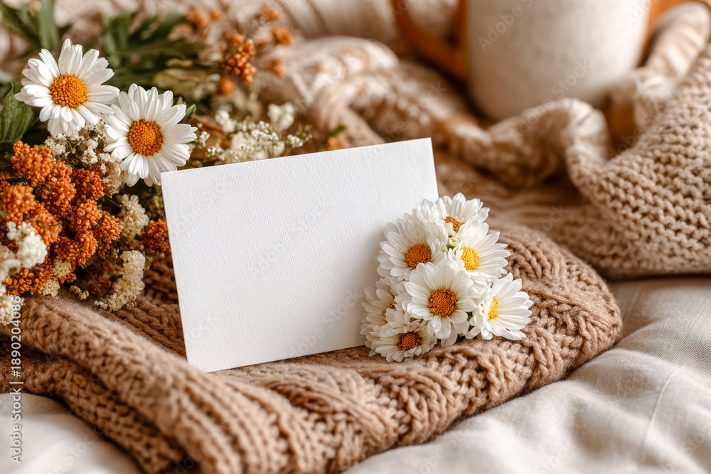 Fototapeta premium Top-view Mother?s Day card on knitted blanket with delicate flowers flat lay