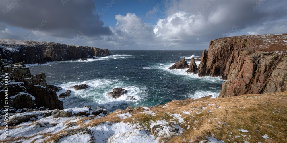 Fototapeta premium Scottish cliff coastline with ocean waves and winter snow