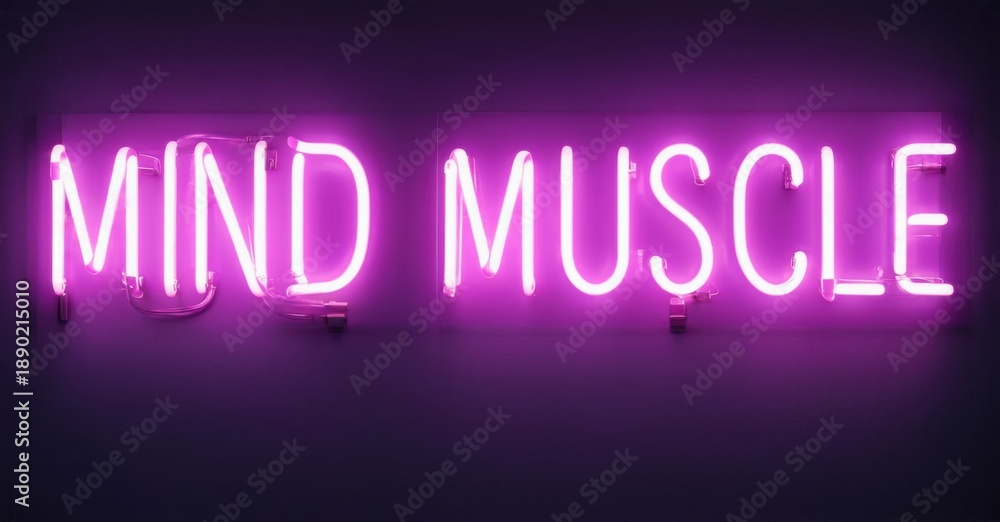 Fototapeta premium Bright purple neon sign displays words mind muscle. Dark background emphasizes glowing text. Simple, motivational message.