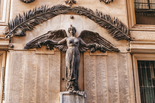 Fotografie Palazzo del Seminario - winged Bronze Angel woman monument - Basilica of San Lor
