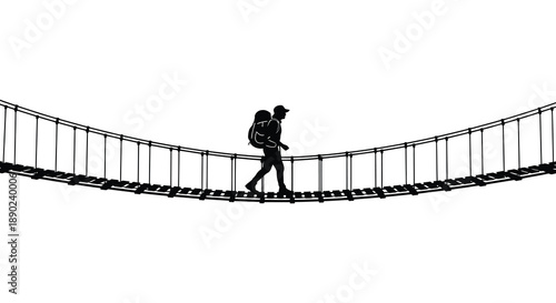A lone hiker carefully walks across a suspended rope bridge carrying a backpack depicted as a striking silhouette high quality professional