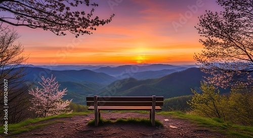 A serene bench overlooking a breathtaking mountain landscape at sunset