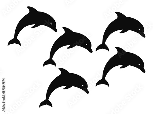 A group of black dolphin silhouettes swimming together in the ocean
