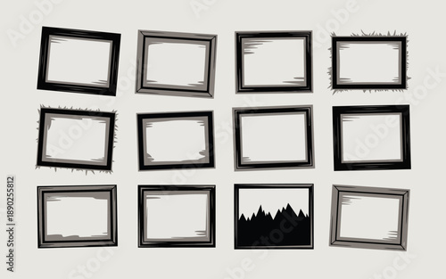 Collection of black picture frames with distressed edges on a gray background.