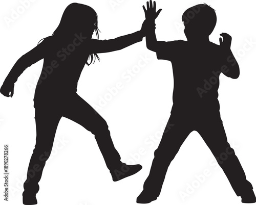 Black silhouettes of two young children playing together and giving a high five isolated on white background for childhood friendship and joy concepts.