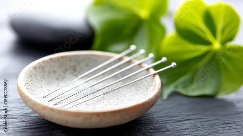 Acupunture acupuncture needles in a bowl, promoting traditional chinese medicine, holistic therapy, and alternative health treatment