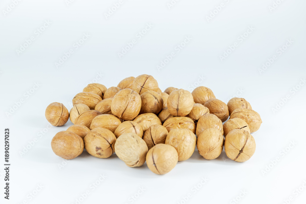 Obraz premium The paper-covered walnuts are placed on a white background.