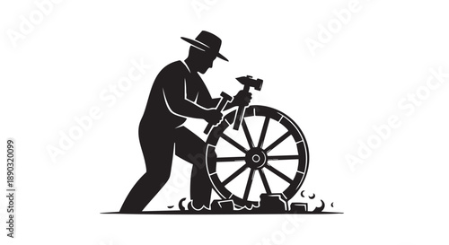 Man repairing a wheel with a hammer standing beside it
