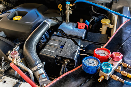 A/C Manifold Gauges Set. Check pressure and leak for use air conditioning systems. Recharging car air conditioner with refrigerant using grade gear with separate gauges to monitor pressure in system.